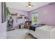 Bedroom with window and charming decor that includes hanging vines and floating shelves at 10576 Greenway Dr, Fishers, IN 46037