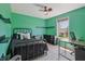 Well-lit bedroom features a dark metal bed frame and a bright window view at 10576 Greenway Dr, Fishers, IN 46037