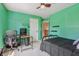 Cozy bedroom with a ceiling fan, an open door to the landing and decor at 10576 Greenway Dr, Fishers, IN 46037
