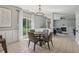 Open dining area featuring wainscoting, backyard views from sliding glass doors and an elegant chandelier at 10576 Greenway Dr, Fishers, IN 46037