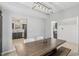 Open-concept dining area featuring rustic table and bench, modern lighting, and easy access to the kitchen at 10576 Greenway Dr, Fishers, IN 46037