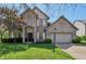 Charming brick home with a two-car garage, arched entryway, and well-manicured lawn at 10576 Greenway Dr, Fishers, IN 46037