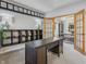 Bright home office with built-in shelving, desk, and glass french doors at 10576 Greenway Dr, Fishers, IN 46037