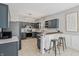 Well-lit kitchen featuring stainless steel appliances, granite countertops, and a cozy breakfast bar at 10576 Greenway Dr, Fishers, IN 46037