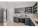 Modern kitchen with stainless steel appliances, ample counter space, and stylish dark cabinets at 10576 Greenway Dr, Fishers, IN 46037