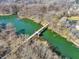 Picturesque aerial view featuring a charming bridge over a calm river at 1074 Reserve Way, Indianapolis, IN 46220