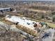 Aerial view showcasing a community building near a wooded area and ample parking at 1074 Reserve Way, Indianapolis, IN 46220