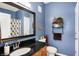 Well-appointed bathroom features stylish blue walls, granite vanity, and decorative accents for a luxurious feel at 1074 Reserve Way, Indianapolis, IN 46220