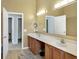 Bathroom featuring double sinks, a large mirror, and plenty of counter space at 1074 Reserve Way, Indianapolis, IN 46220