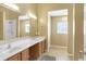 Bathroom featuring double sinks, a large mirror, and natural light at 1074 Reserve Way, Indianapolis, IN 46220