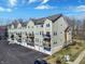 View of condo buildings with multiple stories, garage access, and small balconies at 1074 Reserve Way, Indianapolis, IN 46220