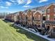Row of brick townhouses with manicured lawns, showcasing curb appeal and community design at 1074 Reserve Way, Indianapolis, IN 46220