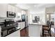 Well-lit kitchen boasts stainless steel appliances, granite countertops, and a stylish island with seating at 1074 Reserve Way, Indianapolis, IN 46220