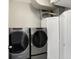 Modern laundry room with new front load washer and dryer, plus storage at 1074 Reserve Way, Indianapolis, IN 46220