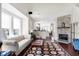 Inviting living room with hardwood floors, fireplace, and open layout to kitchen at 1074 Reserve Way, Indianapolis, IN 46220