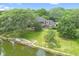 Aerial view of backyard leading to lake with lush green landscaping and mature trees at 10817 Lakeview Dr, Carmel, IN 46033