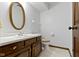 Clean bathroom with wooden vanity, white countertop, and neutral decor at 10817 Lakeview Dr, Carmel, IN 46033