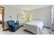 Well-lit bedroom featuring white walls, dresser, and blue chair at 10817 Lakeview Dr, Carmel, IN 46033