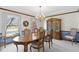 Formal dining room featuring elegant wallpaper, a wood table and a china cabinet at 10817 Lakeview Dr, Carmel, IN 46033