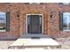 Classic brick home entrance with decorative arched doorway and sidelight windows at 10817 Lakeview Dr, Carmel, IN 46033