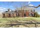 Traditional brick home featuring a symmetrical facade, dormer window and mature landscaping at 10817 Lakeview Dr, Carmel, IN 46033