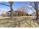 Charming two-story brick home with mature trees in the front yard and shutters at 10817 Lakeview Dr, Carmel, IN 46033
