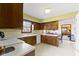 Bright kitchen with wooden cabinets, white countertops, and modern appliances at 10817 Lakeview Dr, Carmel, IN 46033