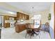 Eat in kitchen with wood cabinets, white countertops, modern appliances, and natural light at 10817 Lakeview Dr, Carmel, IN 46033
