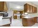 Kitchen featuring wooden cabinets, white countertops, and white appliances at 10817 Lakeview Dr, Carmel, IN 46033