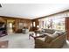 Spacious living room with wood paneling, large windows, and comfortable seating at 10817 Lakeview Dr, Carmel, IN 46033