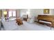 Bright living room featuring patterned furniture, a piano and natural light at 10817 Lakeview Dr, Carmel, IN 46033