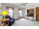 Cozy living room featuring large windows, vintage wallpaper and an arm chair at 10817 Lakeview Dr, Carmel, IN 46033