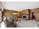 Comfortable living room with wood paneling, brick fireplace, and plenty of natural light at 10817 Lakeview Dr, Carmel, IN 46033