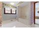 Vintage bathroom with marble bathtub and classic floral wallpaper at 10817 Lakeview Dr, Carmel, IN 46033