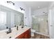 Bright bathroom featuring a double sink vanity with wood cabinets and a glass-enclosed shower at 1120 Oak Hill Ln, Cicero, IN 46034
