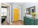 Inviting foyer features a cheerful yellow door and stylish green accent cabinet at 1120 Oak Hill Ln, Cicero, IN 46034