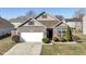 Charming single-Gathering home with a well-manicured front yard and two car garage at 1120 Oak Hill Ln, Cicero, IN 46034
