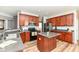 Well-lit kitchen featuring wood cabinets, stainless steel appliances, and a convenient center island at 1120 Oak Hill Ln, Cicero, IN 46034