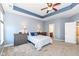 Comfortable main bedroom with tray ceiling, carpet, and ample natural light from the large windows at 1120 Oak Hill Ln, Cicero, IN 46034