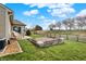 A well-kept backyard with a small patio area, wooden fencing and trees for a serene outdoor experience at 129 W Clear Lake Ln, Westfield, IN 46074