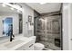 Updated bathroom features a gray color palette, glass enclosed shower, and modern vanity at 129 W Clear Lake Ln, Westfield, IN 46074