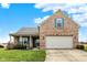 Charming brick home with a well-manicured lawn and two-car garage, perfect for suburban living at 129 W Clear Lake Ln, Westfield, IN 46074