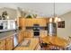 Modern kitchen with stainless steel appliances, wooden cabinetry, and a breakfast bar at 129 W Clear Lake Ln, Westfield, IN 46074