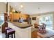 Eat-in kitchen featuring wood cabinets, stainless steel appliances, and a breakfast bar at 129 W Clear Lake Ln, Westfield, IN 46074