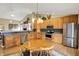 Inviting kitchen with stainless steel appliances, a cozy breakfast nook, and wood cabinetry at 129 W Clear Lake Ln, Westfield, IN 46074
