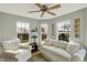 Bright sunroom featuring a ceiling fan, comfortable seating, and views of the backyard at 129 W Clear Lake Ln, Westfield, IN 46074