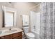 Well-lit bathroom with a vanity sink, patterned shower curtain, and a combination tub and shower at 1382 Redstone Dr, Avon, IN 46123