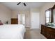 Bedroom with neutral walls and carpet, featuring two dressers, view of ensuite, and good natural light at 1382 Redstone Dr, Avon, IN 46123