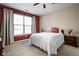 Cozy bedroom featuring a large window, neutral carpeting, and a comfortable bed with decorative pillows at 1382 Redstone Dr, Avon, IN 46123