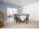 Bright dining room featuring a stylish chandelier, neutral paint, and a view into the sunroom beyond at 1382 Redstone Dr, Avon, IN 46123